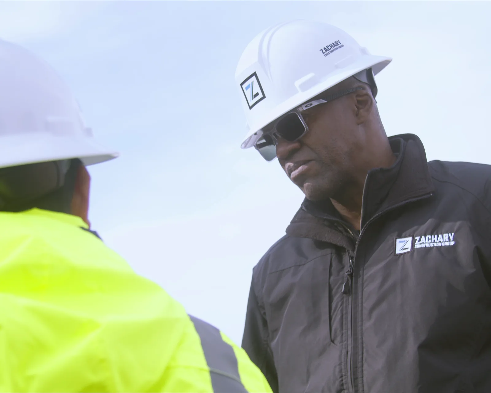 Construction leaders discussing work at a project site